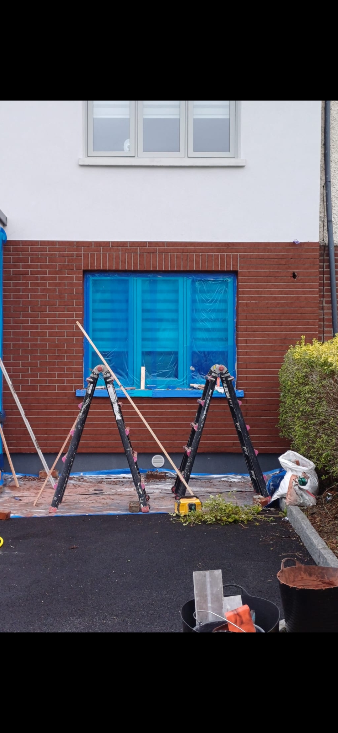 Brick slip finish being installed on the lower elevation of a wrap